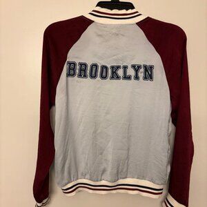 Bomber jacket, maroon and grey. "Brooklyn" sewn across back. Front pockets. Jr's